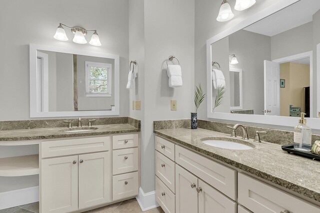 full bath featuring two vanities and tile patterned floors