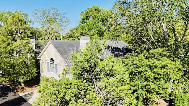 view of side of home featuring a chimney