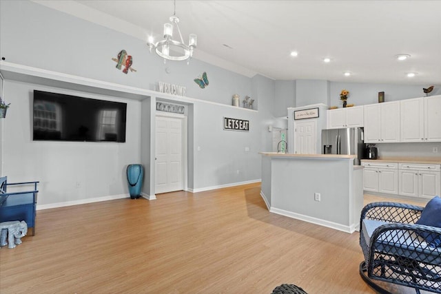 3486 Ashwycke St, Mount Pleasant, SC 29466 - kitchen with stainless steel fridge, lofted ceiling, white cabinetry, light wood-style floors, and light countertops