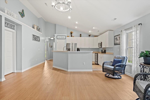 3486 Ashwycke St, Mount Pleasant, SC 29466 - kitchen with appliances with stainless steel finishes, white cabinets, a chandelier, light wood finished floors, and recessed lighting