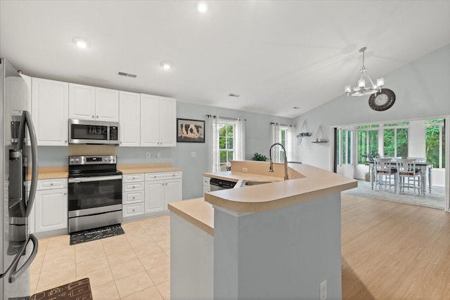 3486 Ashwycke St, Mount Pleasant, SC 29466 - kitchen with appliances with stainless steel finishes, a chandelier, light countertops, white cabinets, and lofted ceiling