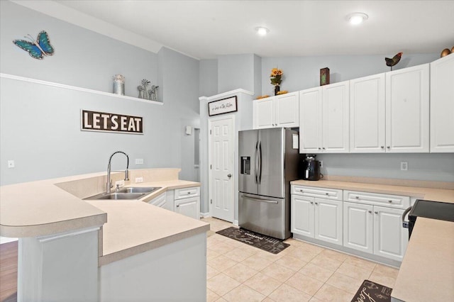 3486 Ashwycke St, Mount Pleasant, SC 29466 - kitchen featuring stainless steel fridge with ice dispenser, light countertops, white cabinets, a center island with sink, and high vaulted ceiling