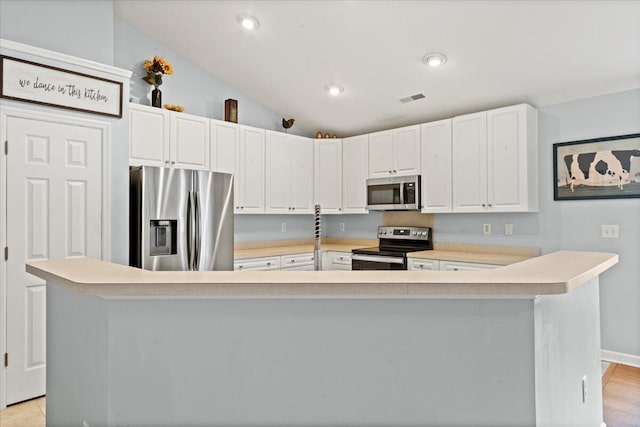 3486 Ashwycke St, Mount Pleasant, SC 29466 - kitchen featuring appliances with stainless steel finishes, light countertops, white cabinets, vaulted ceiling, and recessed lighting