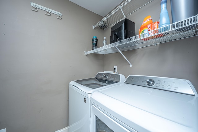 laundry area with independent washer and dryer