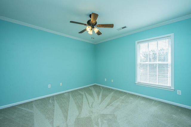 spare room with ceiling fan, ornamental molding, and carpet floors