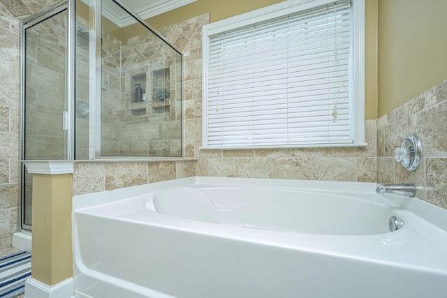 bathroom featuring crown molding, tile walls, and independent shower and bath