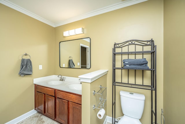 bathroom featuring tile patterned flooring, crown molding, toilet, and vanity