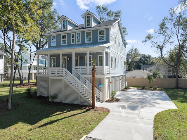 view of front of property featuring a porch, a garage, and a front lawn