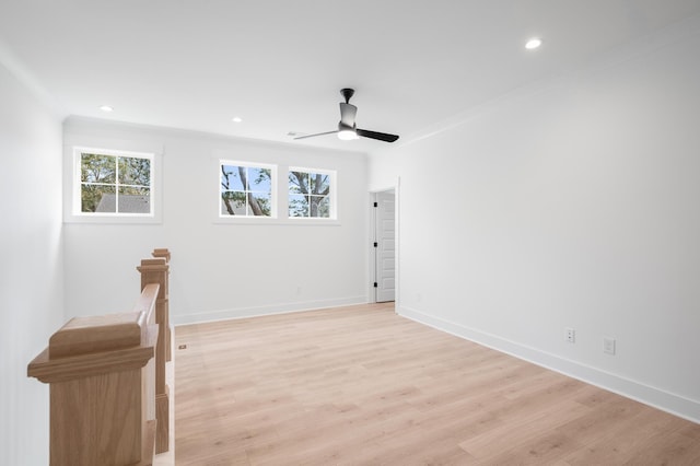 spare room featuring crown molding, ceiling fan, and light hardwood / wood-style floors