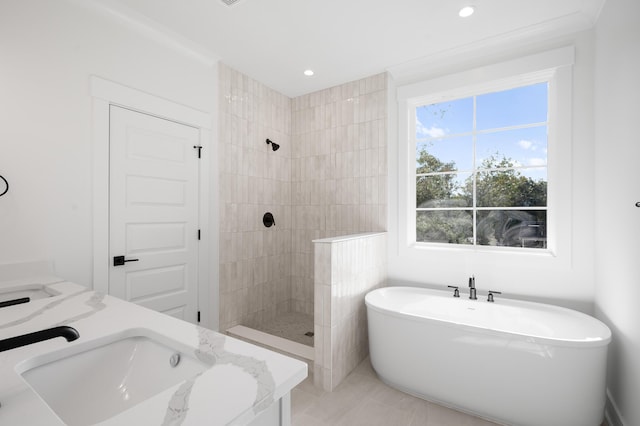 bathroom with vanity, separate shower and tub, and a wealth of natural light