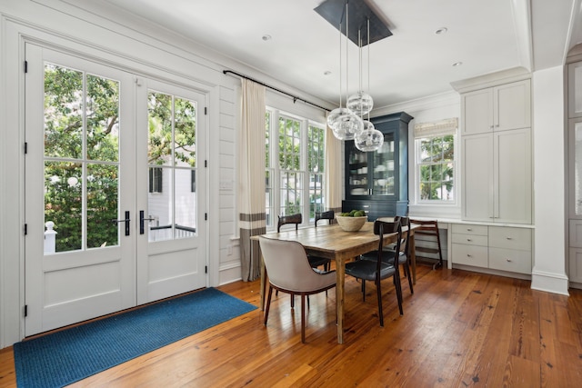 dining space with dark hardwood / wood-style flooring and french doors