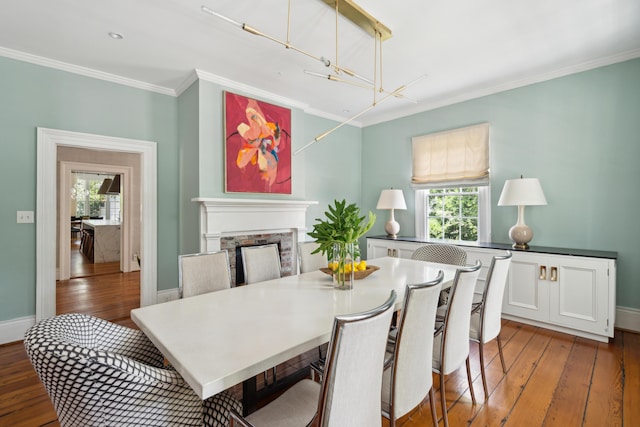 dining room featuring hardwood / wood-style flooring, a healthy amount of sunlight, and ornamental molding