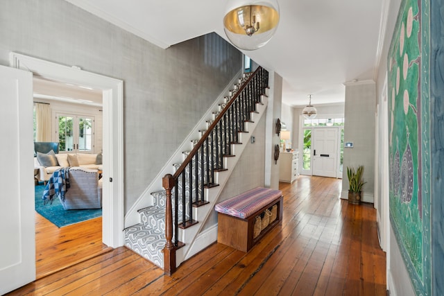 staircase featuring hardwood / wood-style flooring and crown molding