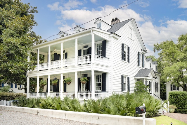 view of front of property with ceiling fan, a balcony, and covered porch