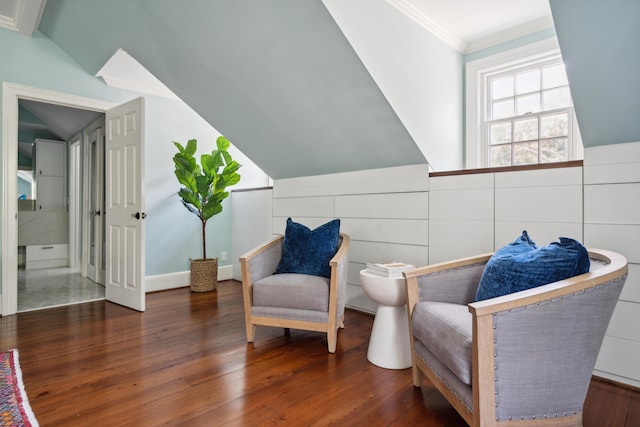 sitting room with ornamental molding, vaulted ceiling, and dark hardwood / wood-style floors