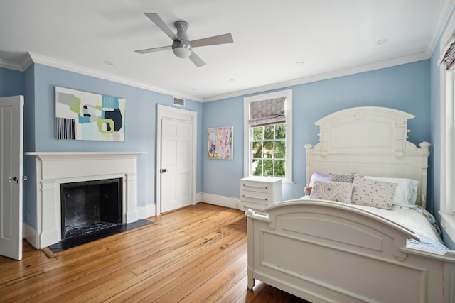 bedroom with crown molding, ceiling fan, and wood-type flooring