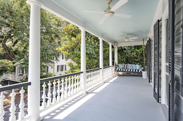 deck featuring covered porch and ceiling fan