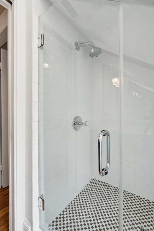 bathroom featuring a shower with shower door