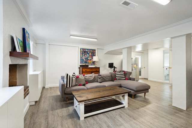 living room featuring hardwood / wood-style flooring and ornamental molding