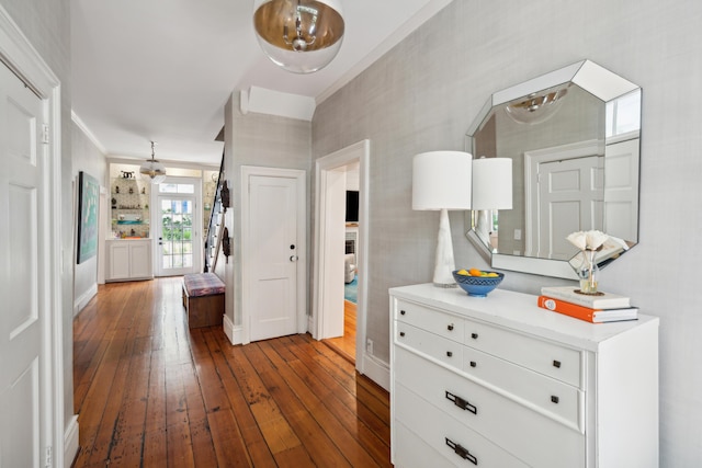 hallway with crown molding and dark hardwood / wood-style flooring