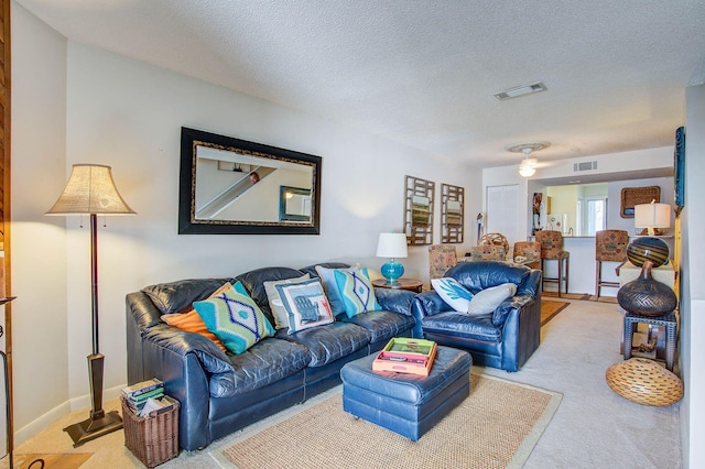 living room with carpet floors and a textured ceiling