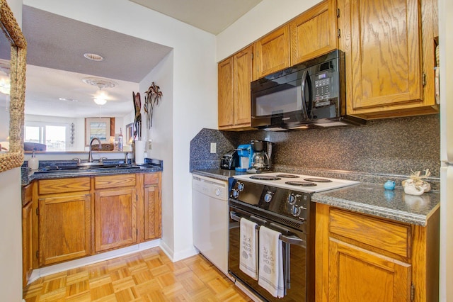 kitchen with a textured ceiling, white appliances, tasteful backsplash, and sink