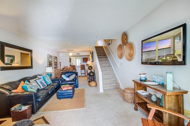 living room with a textured ceiling and light carpet