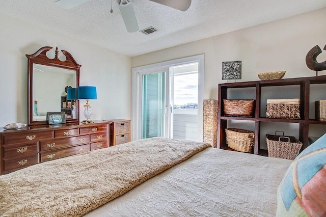 bedroom with a textured ceiling and ceiling fan