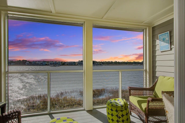 sunroom / solarium with a water view and a wealth of natural light