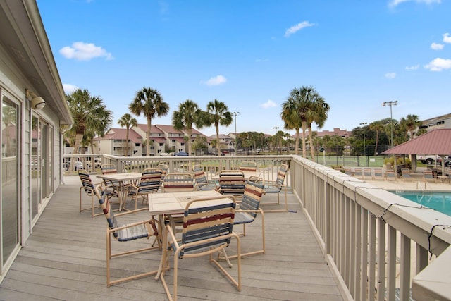 wooden terrace featuring a community pool