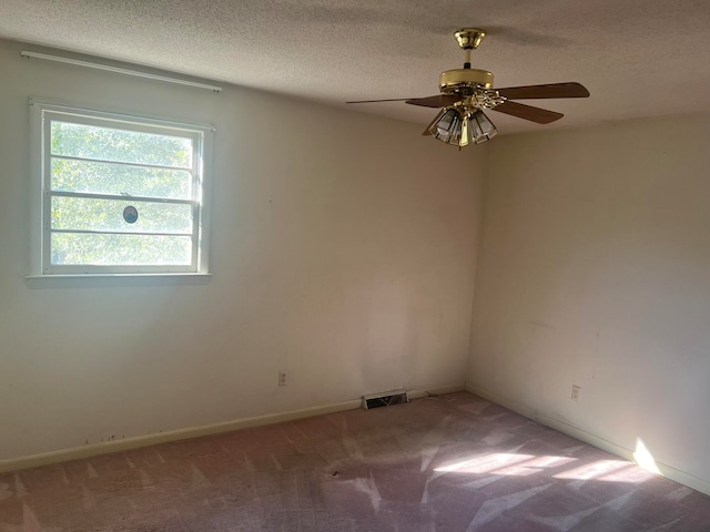 empty room featuring carpet flooring, ceiling fan, and a textured ceiling