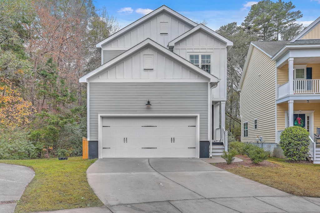 view of front of property with a garage and a front lawn