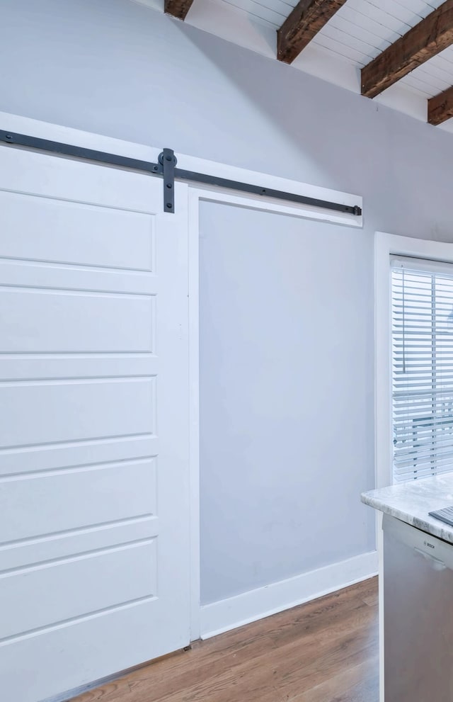 interior details with a barn door and wood-type flooring