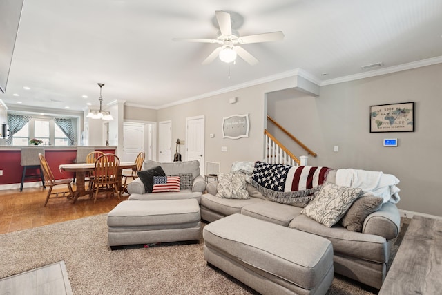 5511 Colonial Chatsworth Cir N, Charleston, SC 29418 - living area with wood finished floors, crown molding, ceiling fan, stairway, and a chandelier