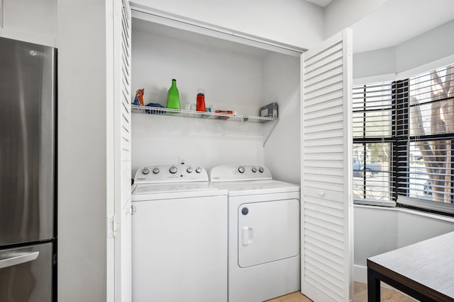 washroom with washing machine and dryer and laundry area