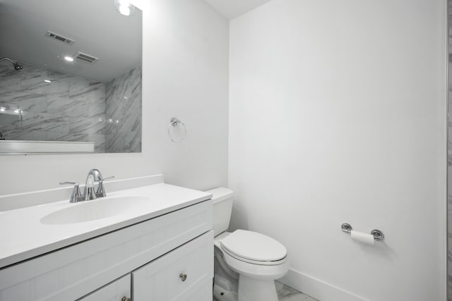 bathroom featuring toilet, vanity, visible vents, marble finish floor, and walk in shower