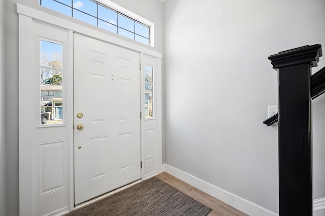 entrance foyer featuring baseboards and wood finished floors