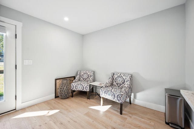 living area with light wood finished floors and baseboards