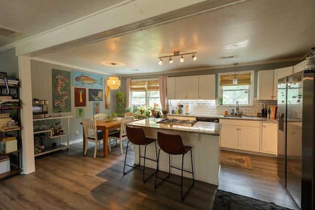 716 White Oak Dr, Charleston, SC 29407 - kitchen with ornamental molding, stainless steel appliances, a sink, dark wood finished floors, and white cabinetry