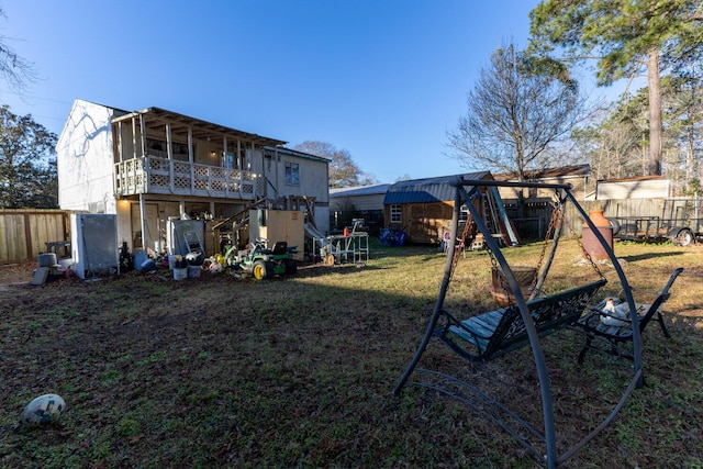 back of property with a playground and a lawn