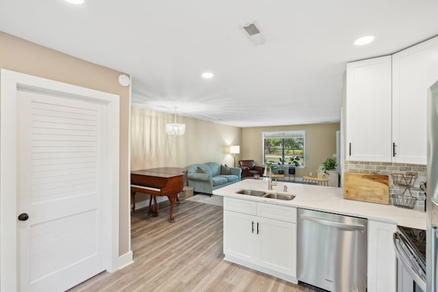 1166 Julian Clark Rd, Charleston, SC 29412 - kitchen with appliances with stainless steel finishes, a sink, white cabinets, a peninsula, and recessed lighting