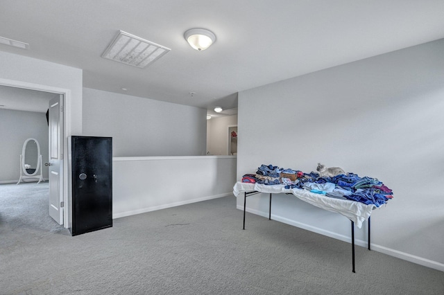 miscellaneous room featuring carpet flooring, visible vents, and baseboards