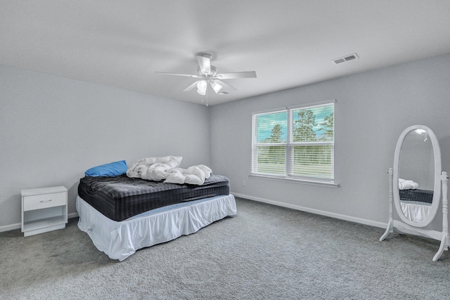 bedroom featuring visible vents, carpet floors, baseboards, and ceiling fan