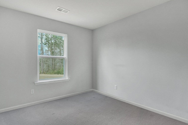 unfurnished room featuring visible vents, carpet flooring, and baseboards