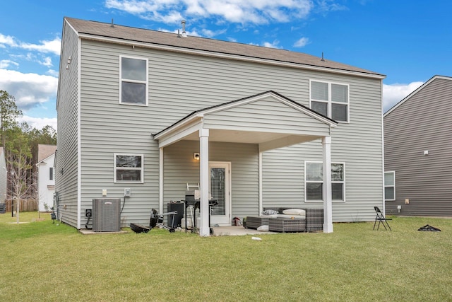 rear view of property featuring an outdoor living space, cooling unit, a yard, and a patio area