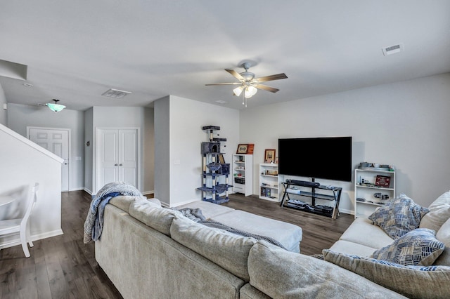 living room featuring a ceiling fan, visible vents, and dark wood-style flooring