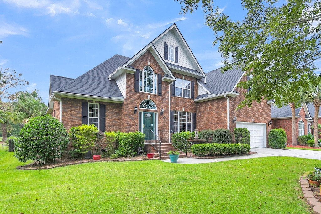 view of property with a front yard and a garage