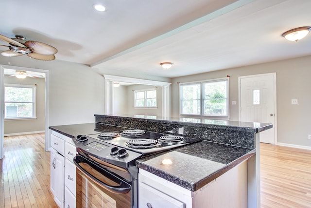 1834 Cornish Ave, Charleston, SC 29412 - kitchen featuring black / electric stove, a ceiling fan, dark countertops, white cabinets, and light wood-style flooring