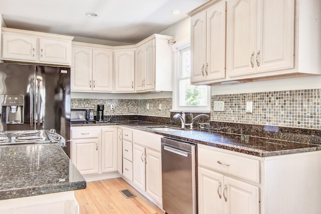1834 Cornish Ave, Charleston, SC 29412 - kitchen featuring stainless steel appliances, dark stone countertops, visible vents, and light wood-style floors