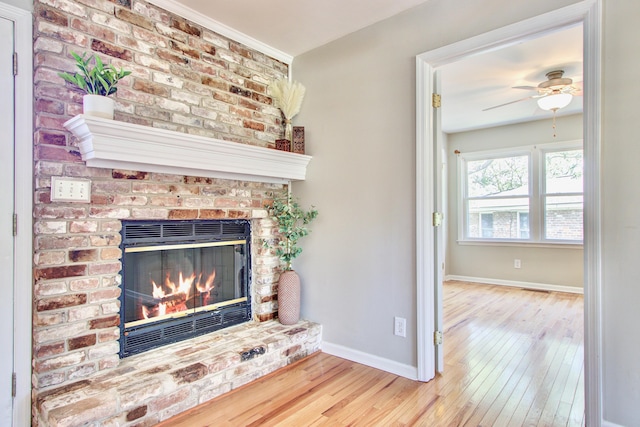 1834 Cornish Ave, Charleston, SC 29412 - unfurnished living room featuring a brick fireplace, a ceiling fan, baseboards, and wood-type flooring